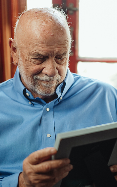 resident looking at a framed picture of loved ones