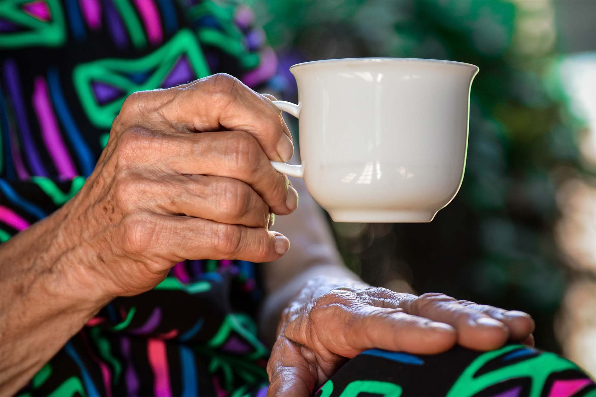 resident with hot drink in their hand