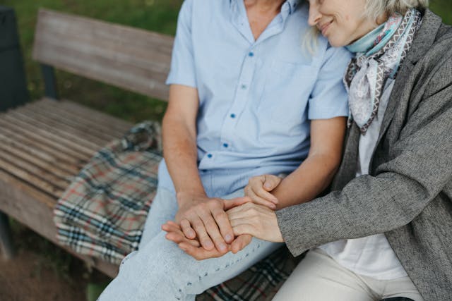 resident holding hands with loved one