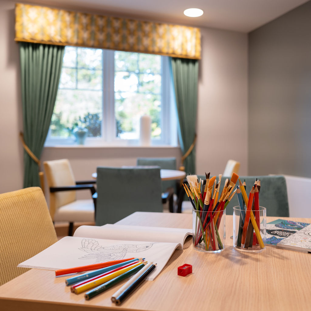 our activities room with tables and chairs with colourful pens