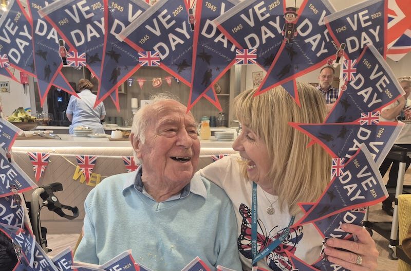 resident and one of our team holding up a VE day frame