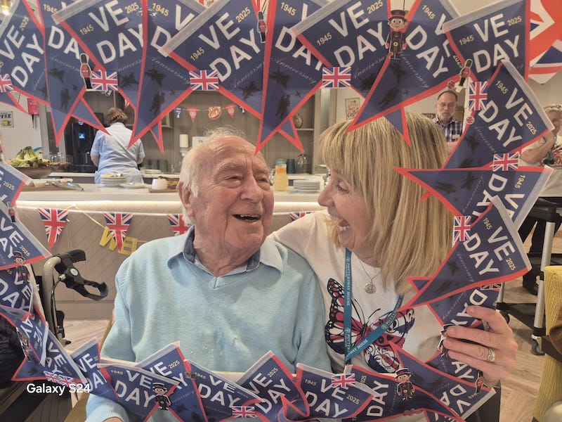 resident and one of our team holding up a VE day frame
