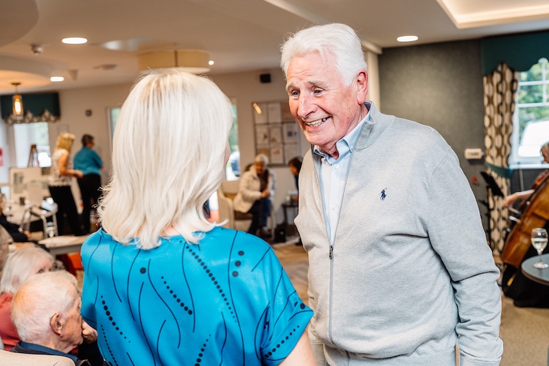 resident and team member chatting together