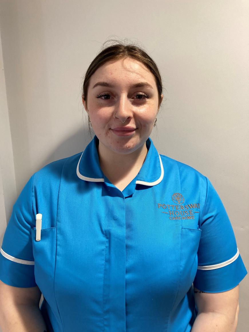 lady smiling at camera for staff photo