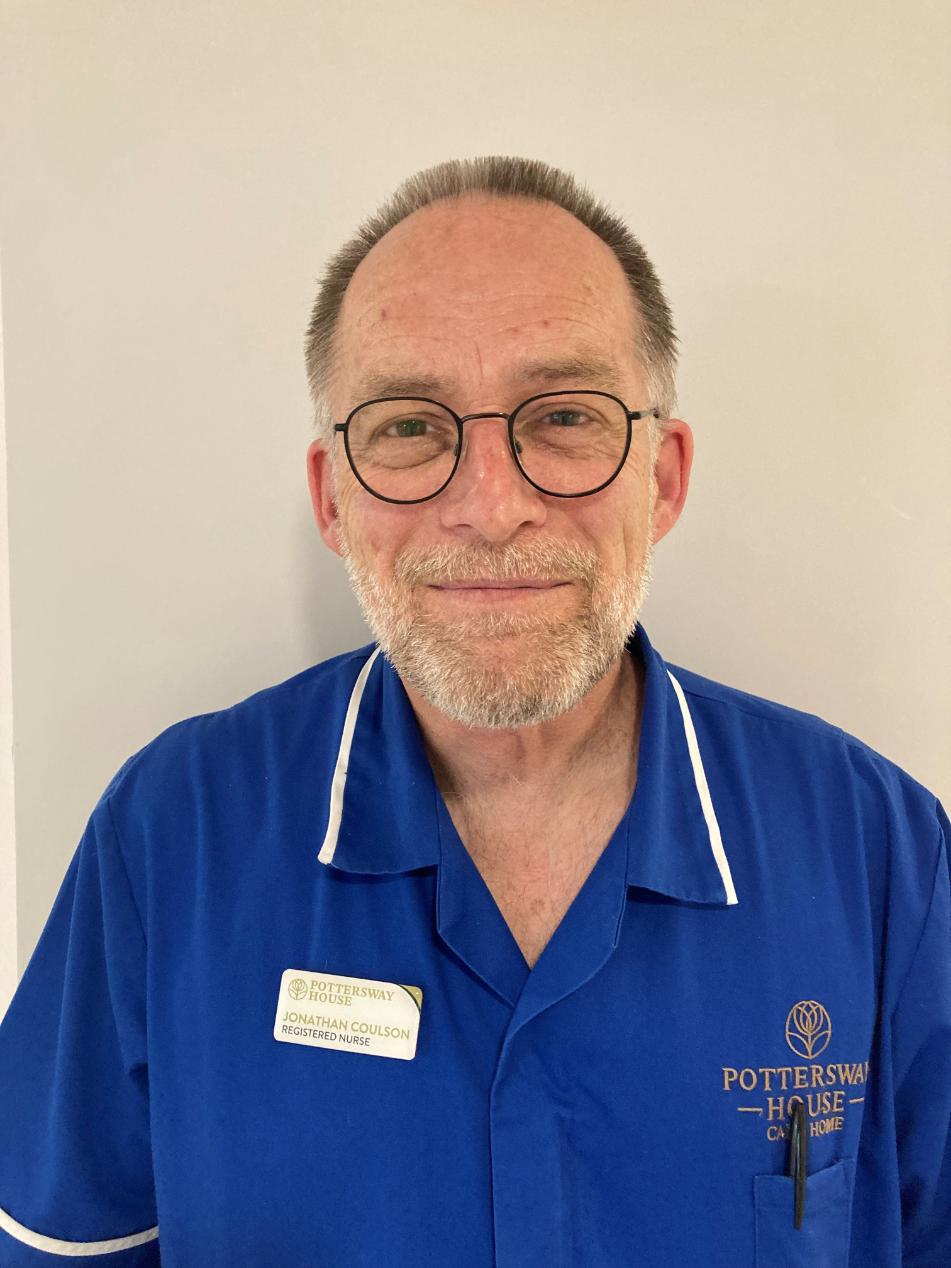 man smiling at camera for staff photo