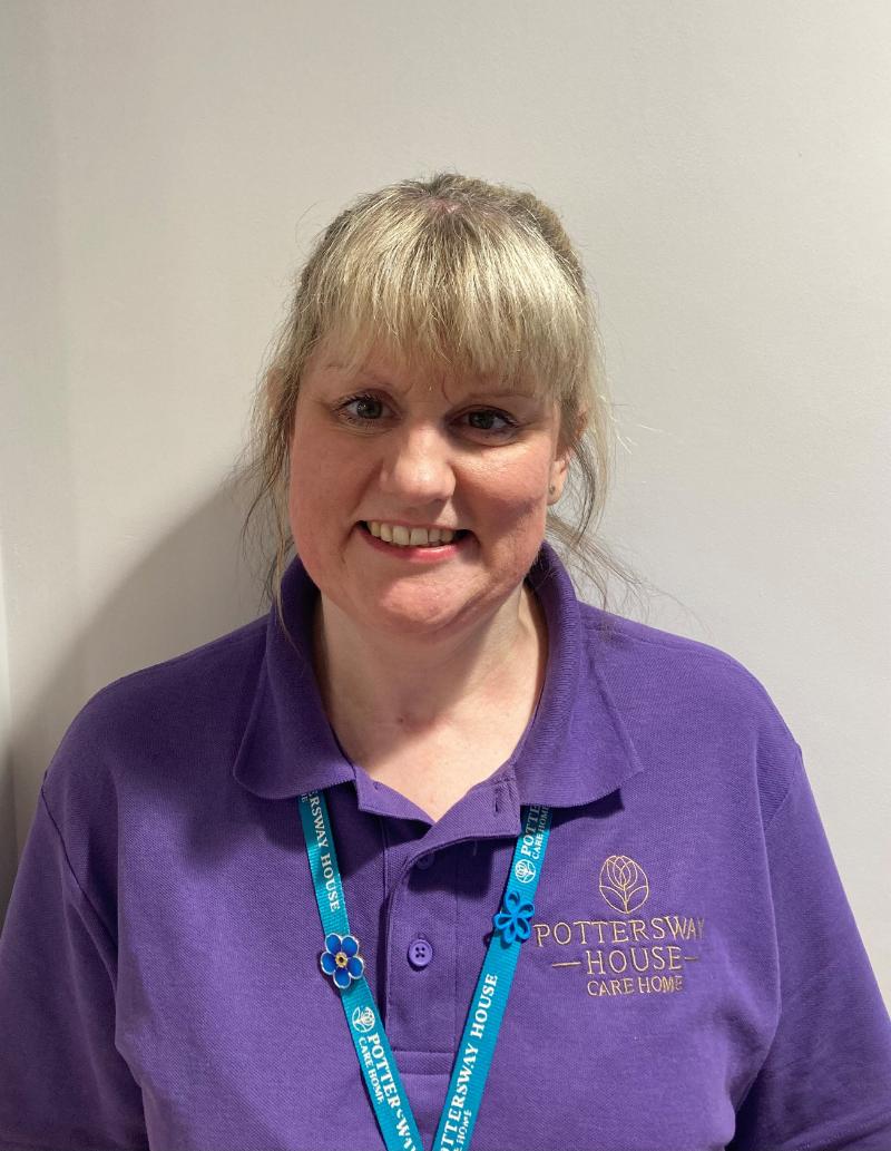 lady smiling at camera for staff photo