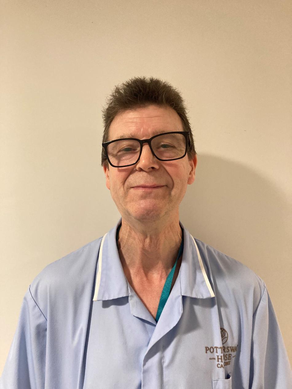 person with glasses posing for staff photo