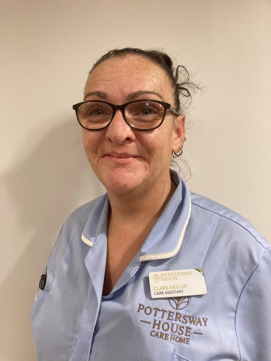 lady with glasses posing for staff photo
