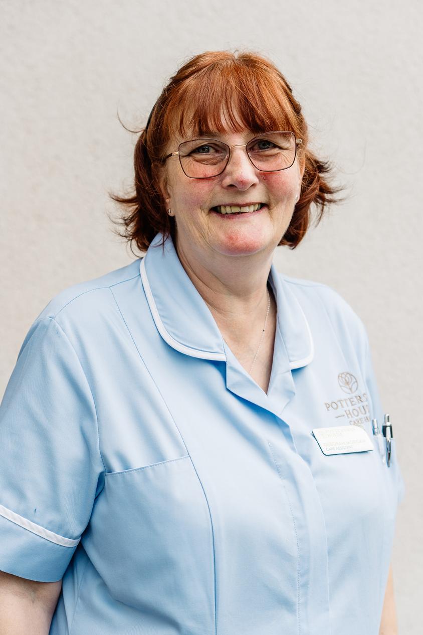 lady with glasses posing for staff photo