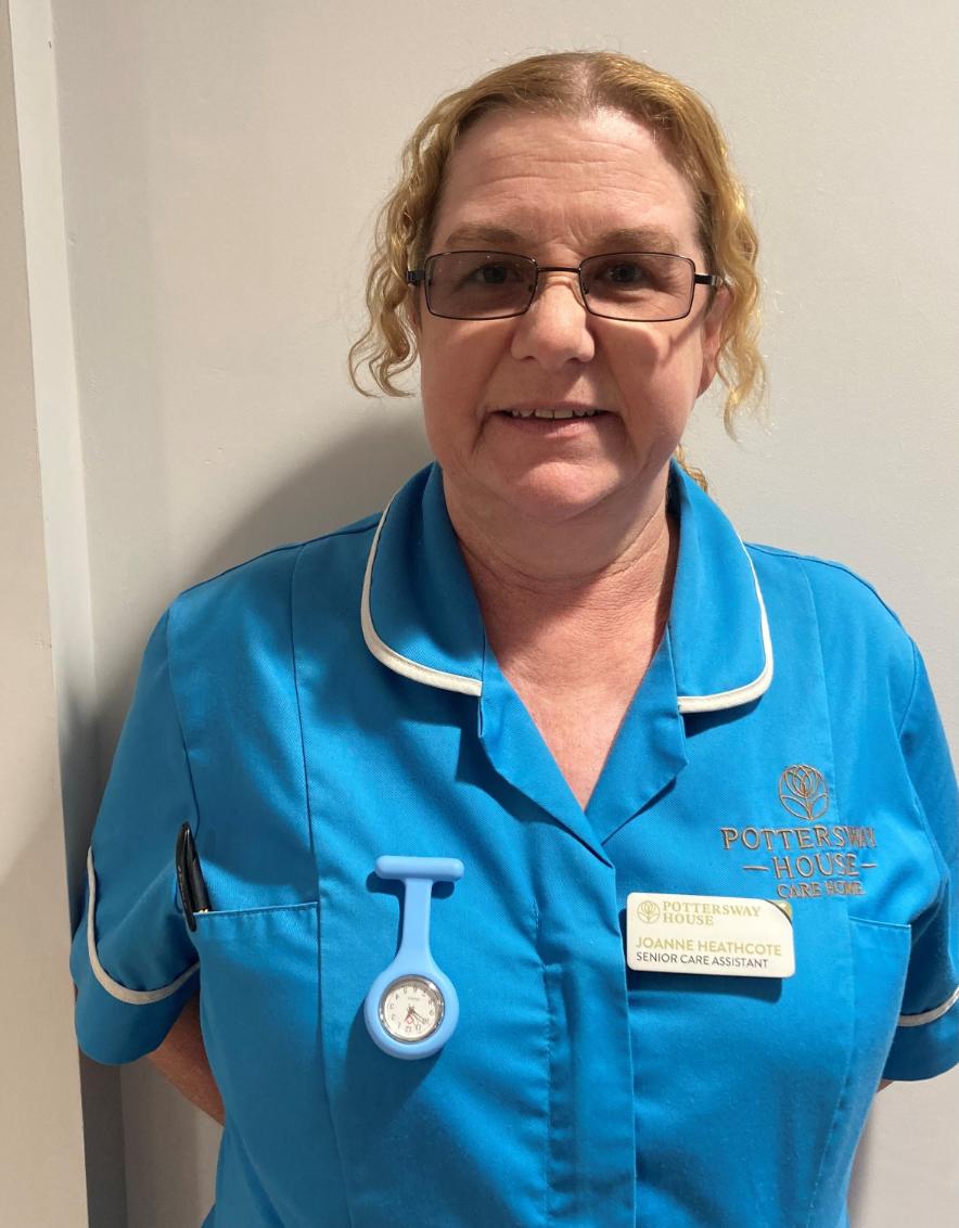 lady with glasses posing for staff photo