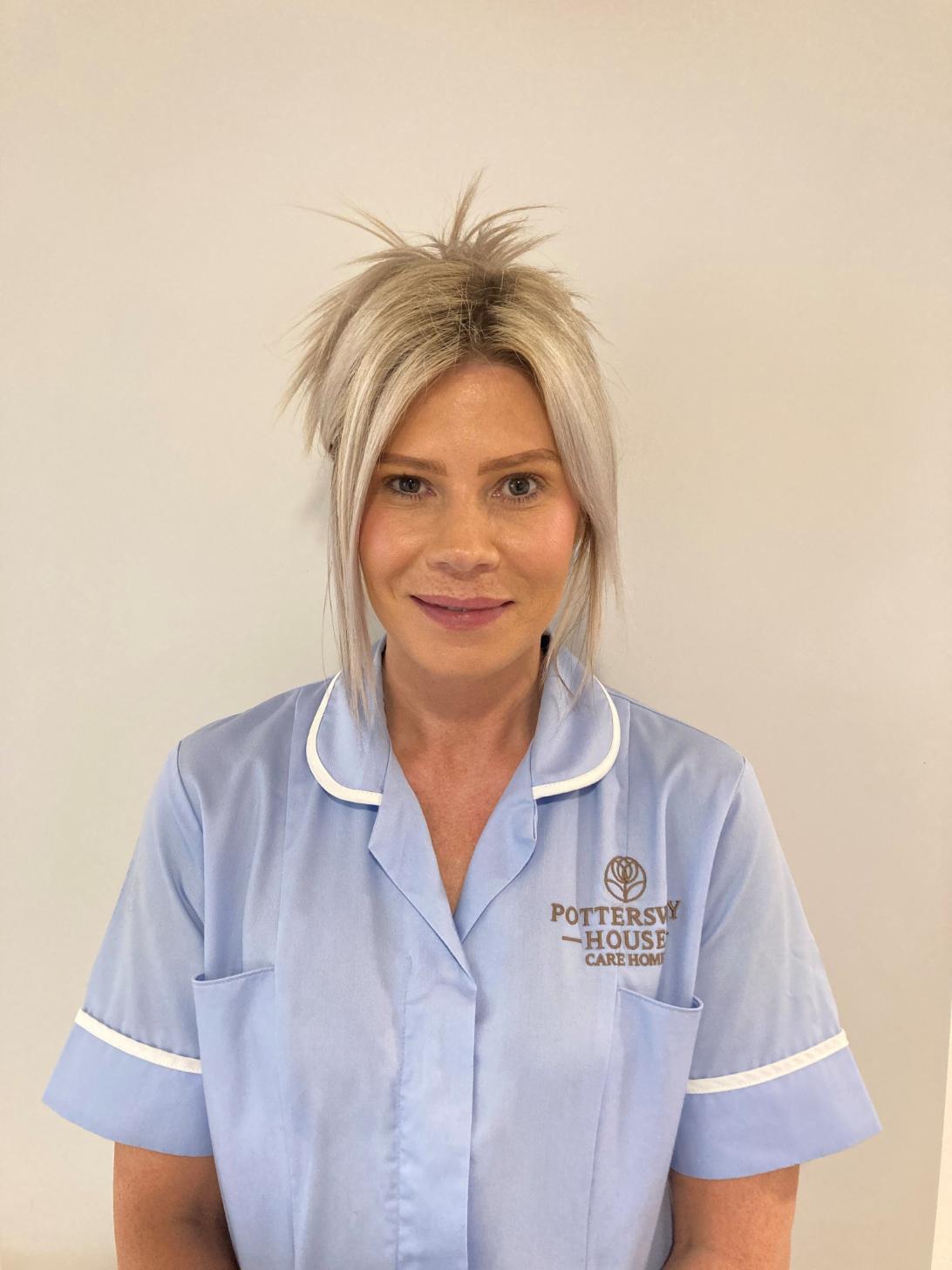 lady with blonde hair posing for staff photo