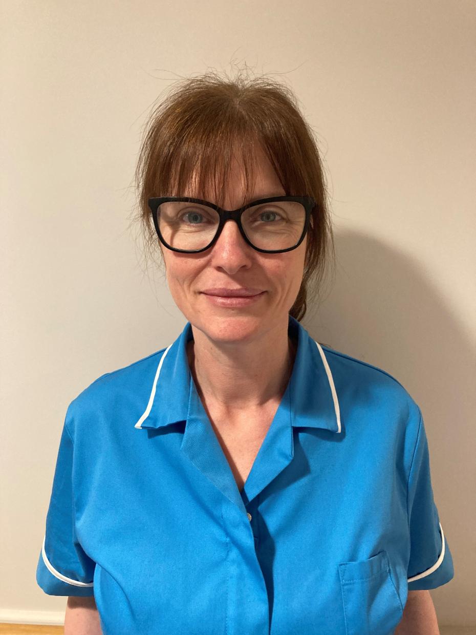 lady with glasses posing for staff photo