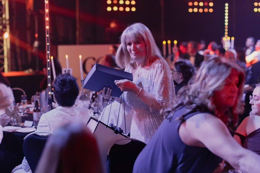 lady in crowd with her award
