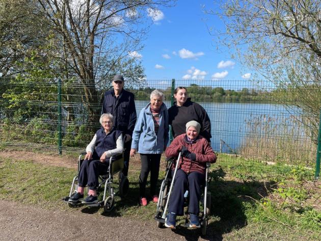 residents standing by a lake