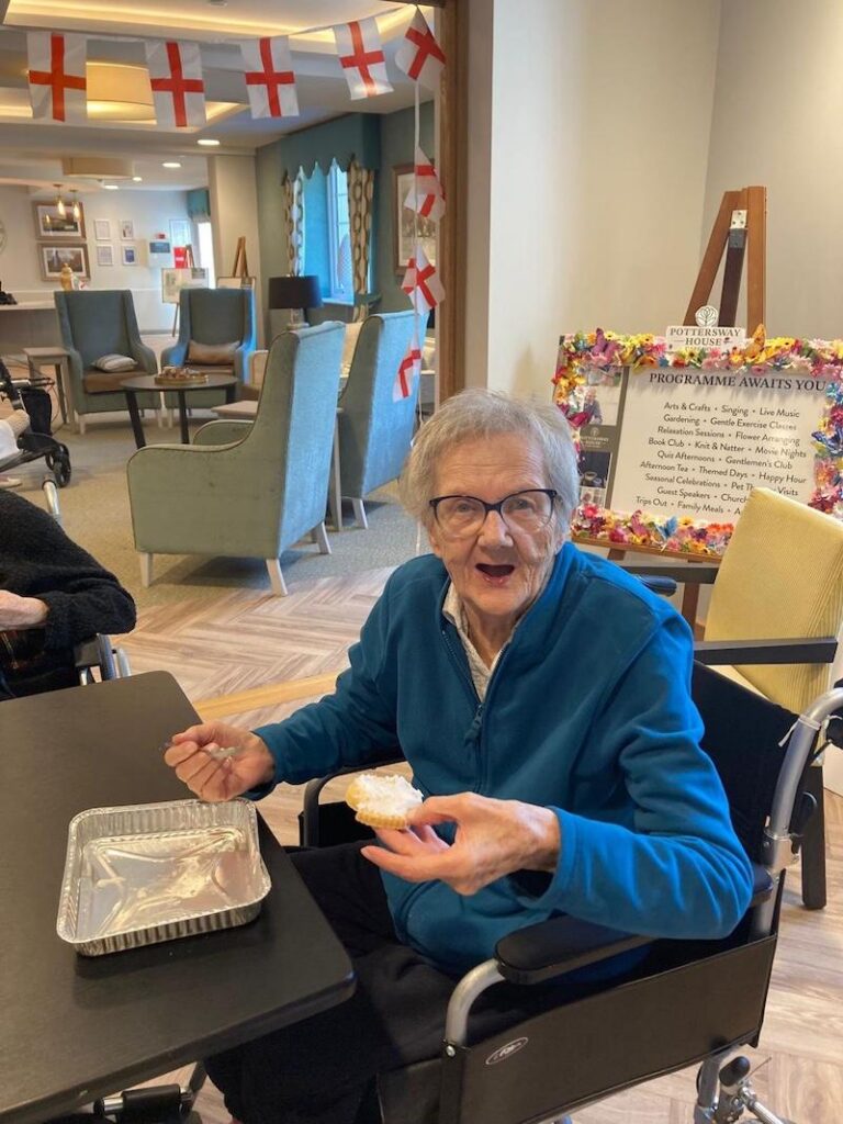 female residents sat down at the table enjoying a biscuit
