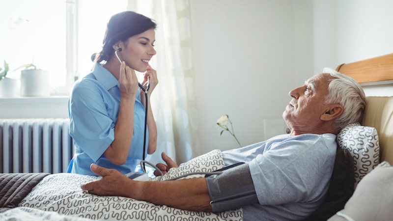 nurse taking a residents blood pressure