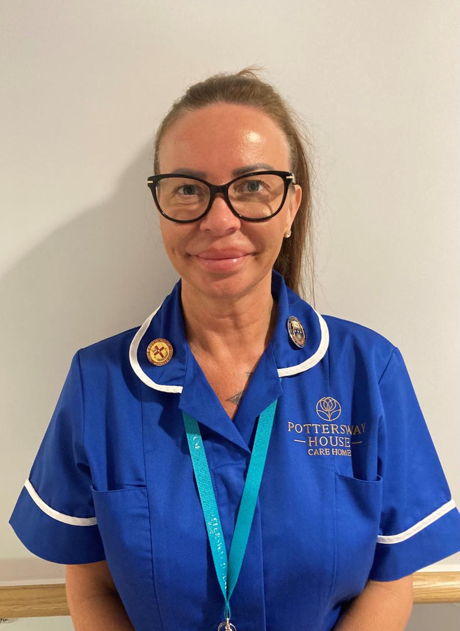 lady with glasses posing for staff photo