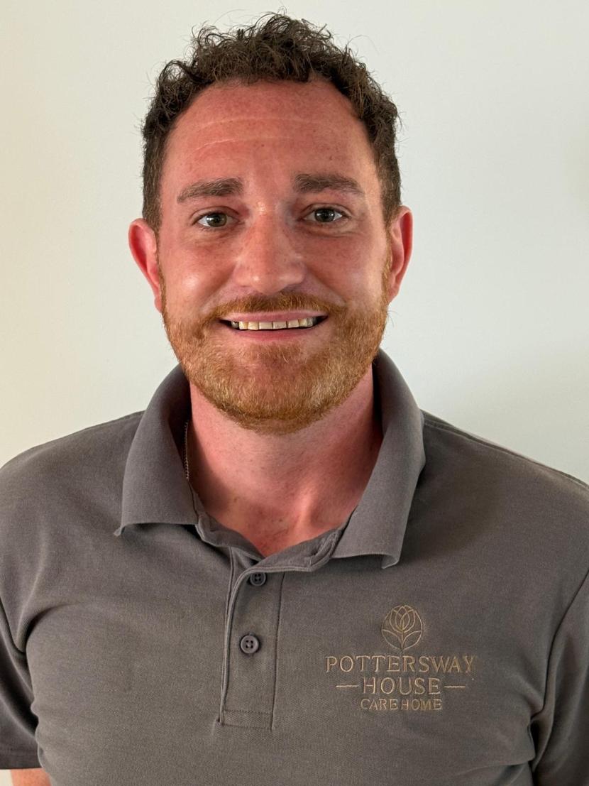 man smiling at camera for staff photo