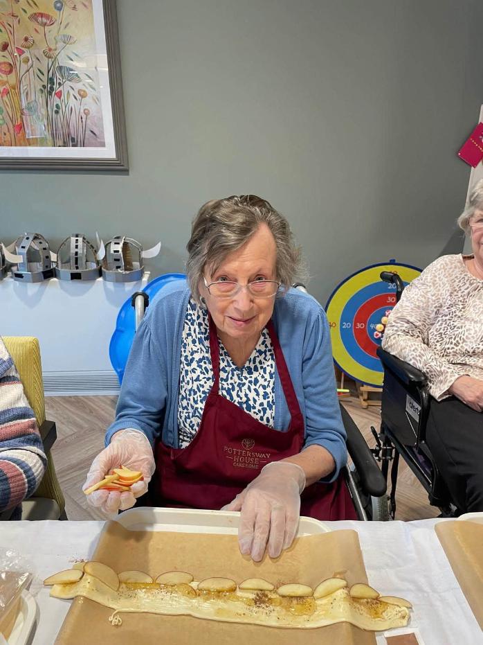 older lady sat down cooking