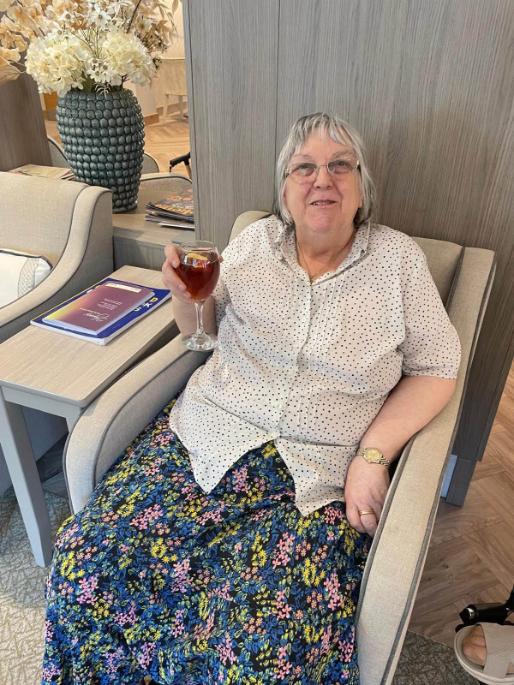 older lady holding up a glass