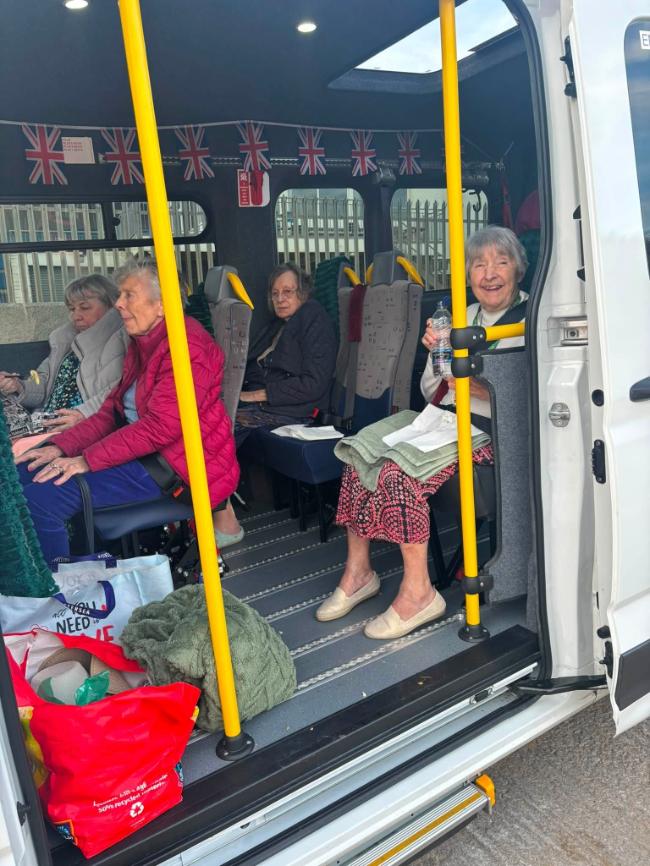 older ladies sat on a minibus